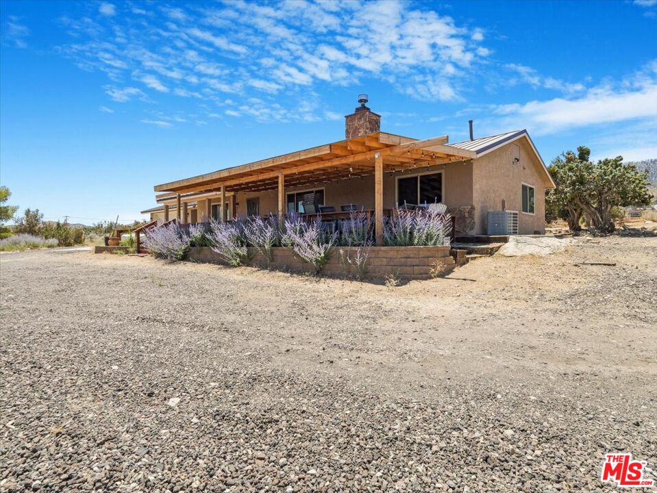 9446 Green Road Pinon Hills, CA 92372 - Photo 3 of 24 a front view of a house with a yard