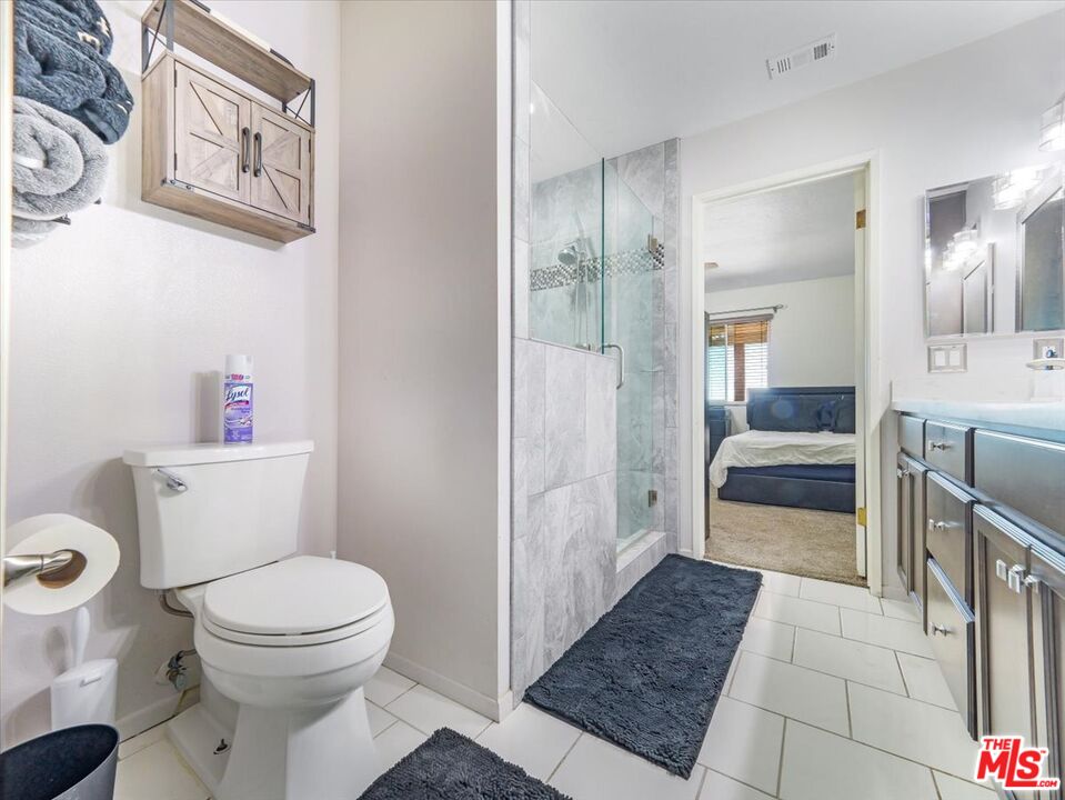 9446 Green Road Pinon Hills, CA 92372 - Photo 5 of 24 a bathroom with a toilet a sink and a mirror