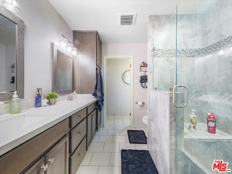 9446 Green Road Pinon Hills, CA 92372 - Photo 7 of 24 a bathroom with a double vanity sink a toilet and shower