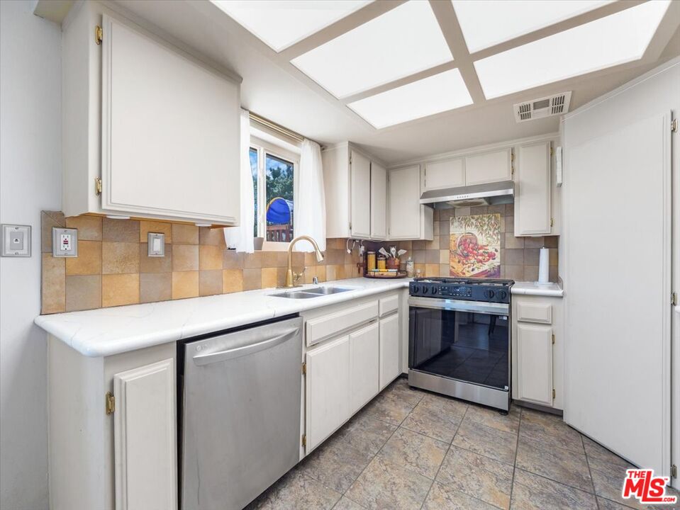 9446 Green Road Pinon Hills, CA 92372 - Photo 10 of 24 a kitchen with stainless steel appliances granite countertop a sink and a stove