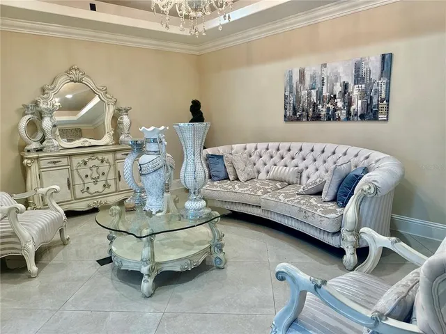 a living room with furniture and a chandelier