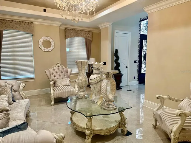 a living room with furniture and a chandelier