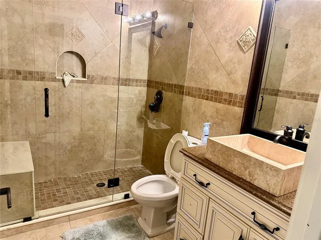 a bathroom with a sink toilet and shower
