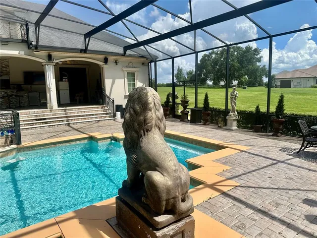 a view of a porch with furniture and a yard