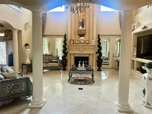 a living room with furniture a fireplace and a flat screen tv