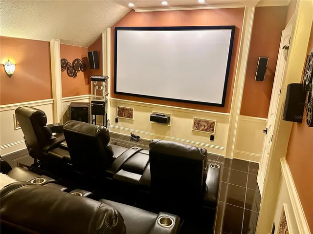 a media room with lots of chairs and a projector screen