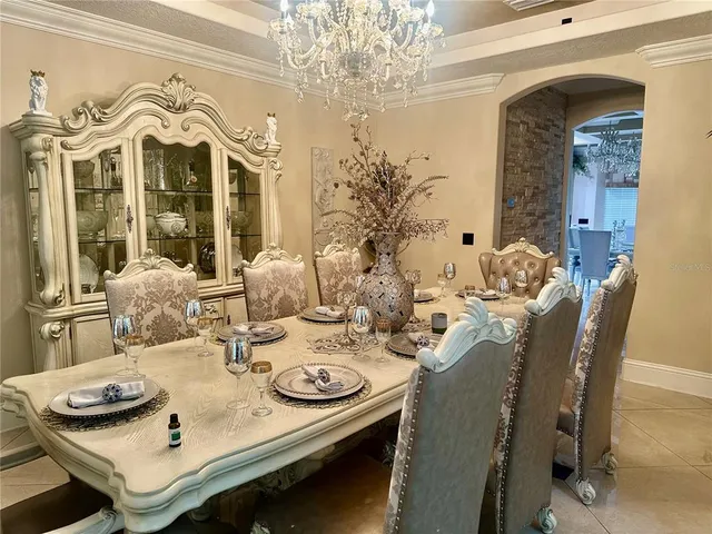 a dining room with furniture and chandelier
