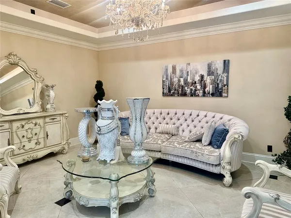 a living room with furniture and a chandelier