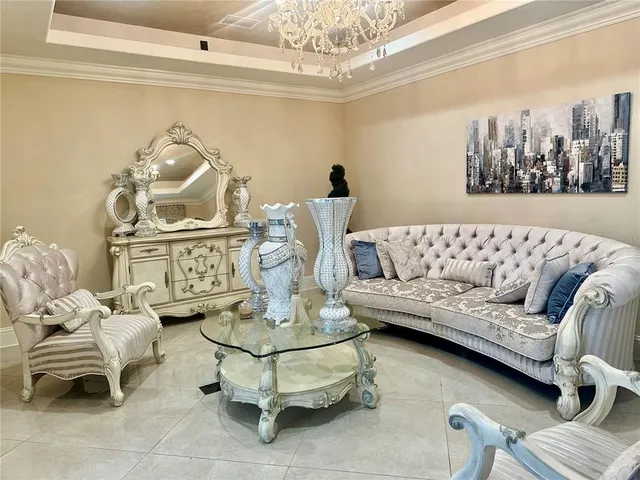 a living room with furniture and a chandelier