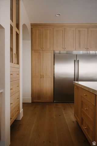 2281 South Crimson Cliffs Way St. George, UT 84790 - Photo 16 of 47 Kitchen featuring built in refrigerator, dark wood-style floors, arched walkways, and wood finish cabinetry