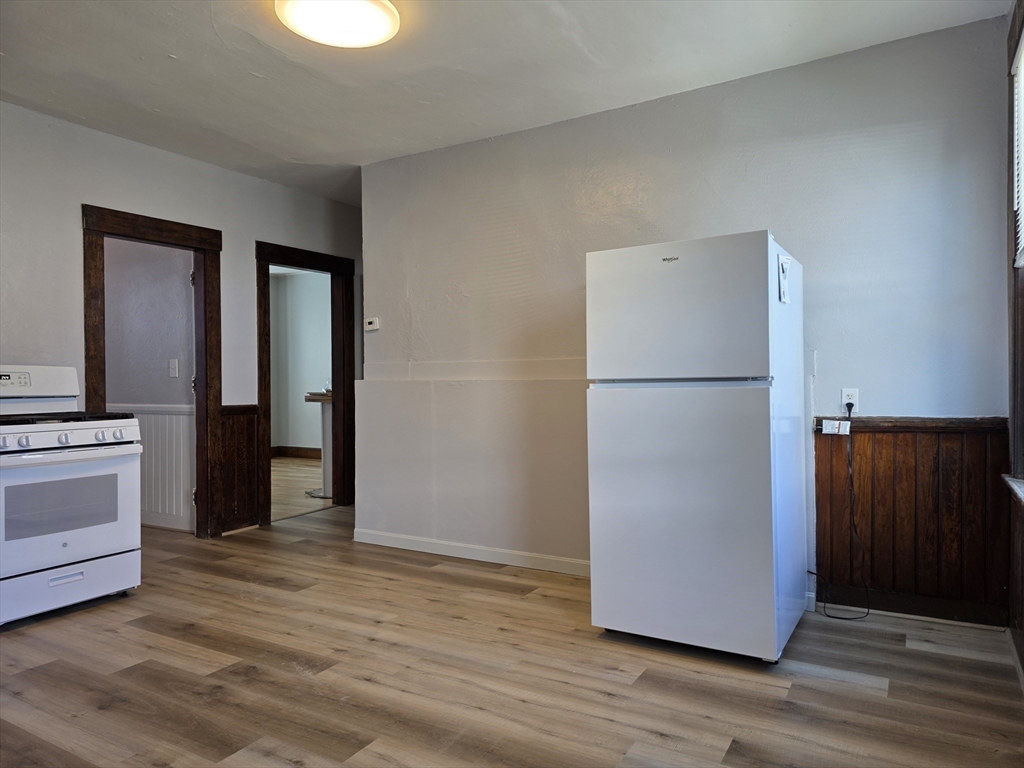 2 Hillside Street, Unit 3 Worcester, MA 01610 - Photo 15 of 30 a view of a kitchen with a refrigerator and a stove