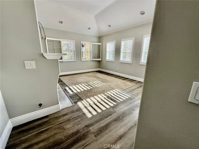 a view of an empty room and wooden floor
