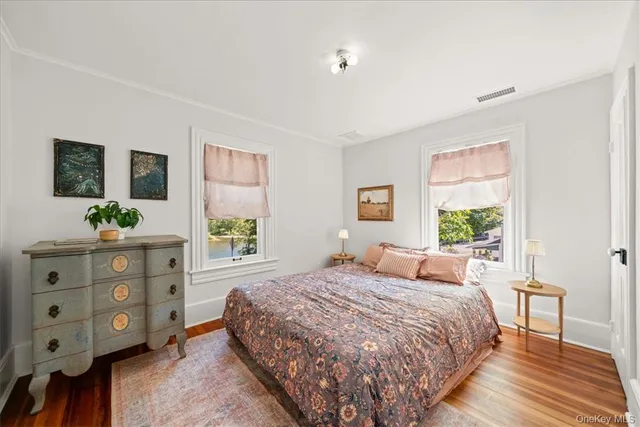 a bedroom with a bed a dresser and a window