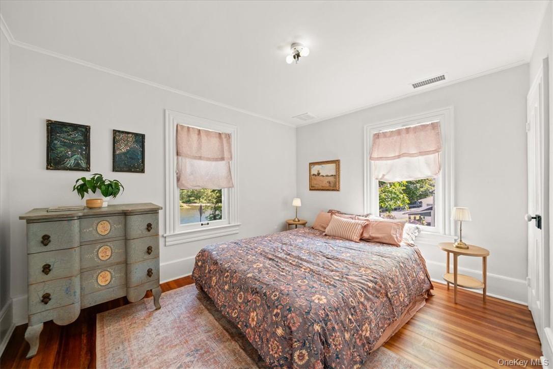 2585 River Road Damascus, PA 18415 - Photo 13 of 41 a bedroom with a bed a dresser and a window