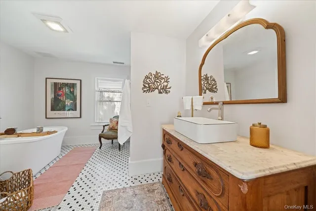 a room with a sink and a mirror