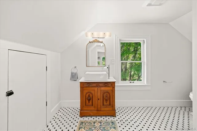 a bathroom with a sink a vanity and a shower