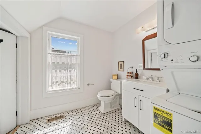 a bathroom with a sink toilet vanity and tub