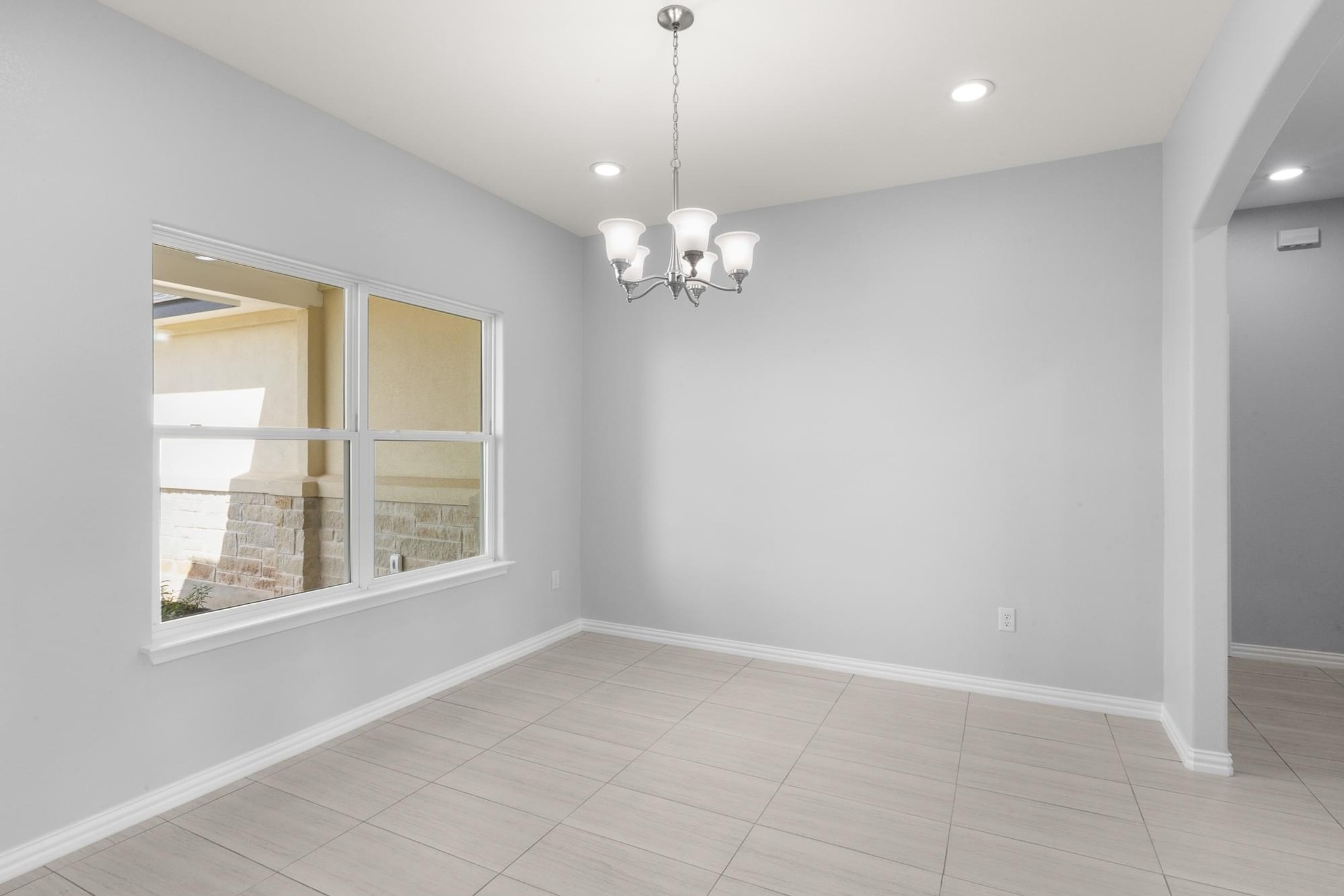 1136 County Road 484 Elgin, TX 78621 - Photo 5 of 37 Spare room with arched walkways, a chandelier, and recessed lighting