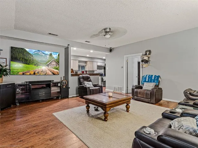 a kitchen with stainless steel appliances granite countertop a refrigerator and a stove top oven