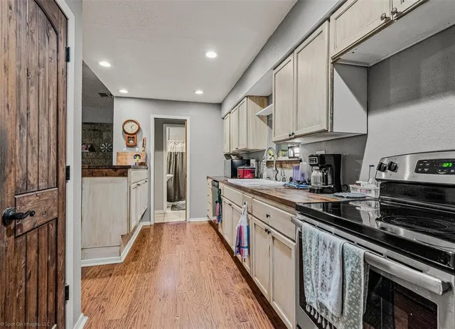 a kitchen with kitchen island granite countertop lots of counter top space and refrigerator