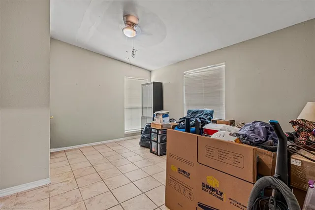 a view of a swimming pool with a bench and trees around