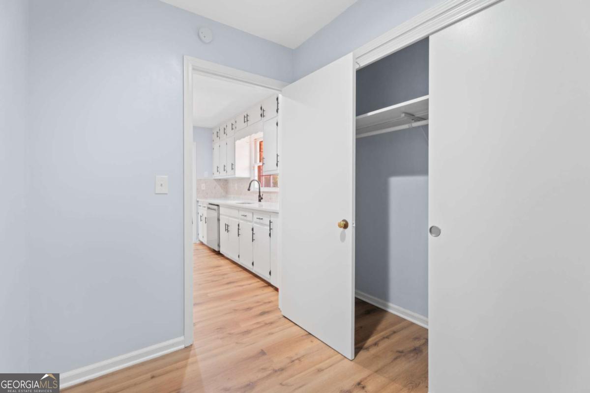 865 Old Tucker Road Stone Mountain, GA 30087 - Photo 20 of 57 a view of a hallway with wooden floor and staircase