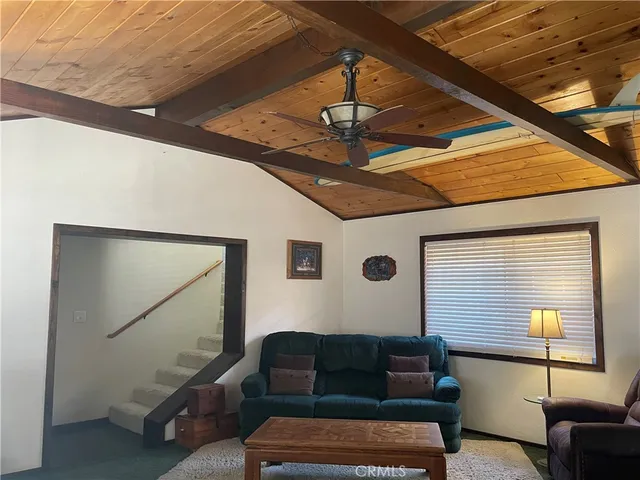a kitchen with stainless steel appliances kitchen island granite countertop a sink and a refrigerator