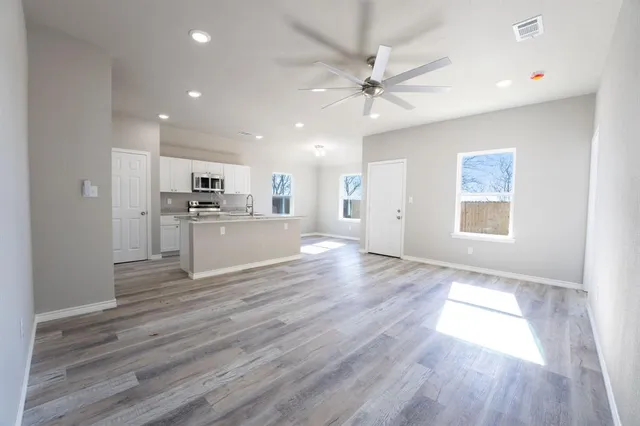 a view of a kitchen with a stove cabinets and wooden floor