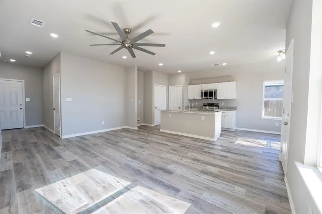 a view of a kitchen with a sink a refrigerator and a fireplace