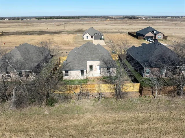 an aerial view of a house with a lake view