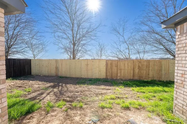 a view of a backyard of the house