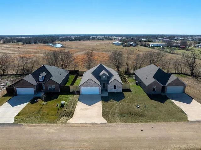 an aerial view of a house with lake view