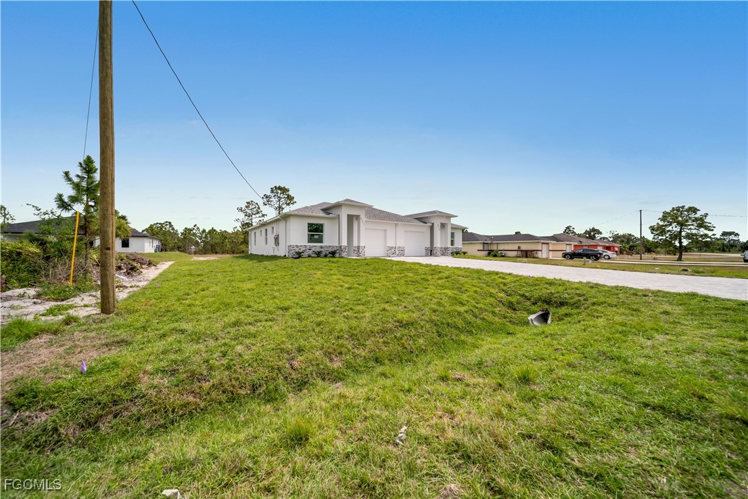 1155 Countess Avenue Lehigh Acres, FL 33974 - Photo 16 of 36 a view of a house with a big yard