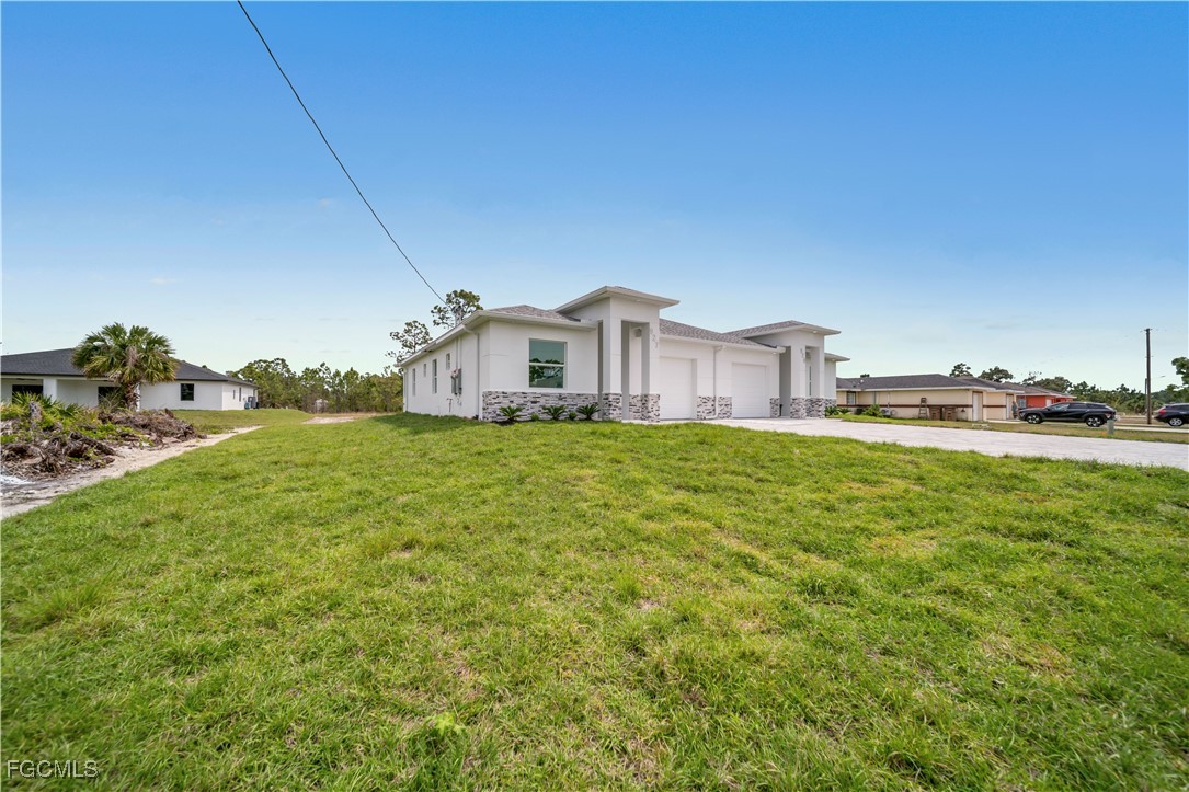 1155 Countess Avenue Lehigh Acres, FL 33974 - Photo 17 of 36 a house view with a garden space