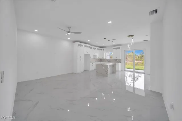 a view of kitchen with windows and refrigerator