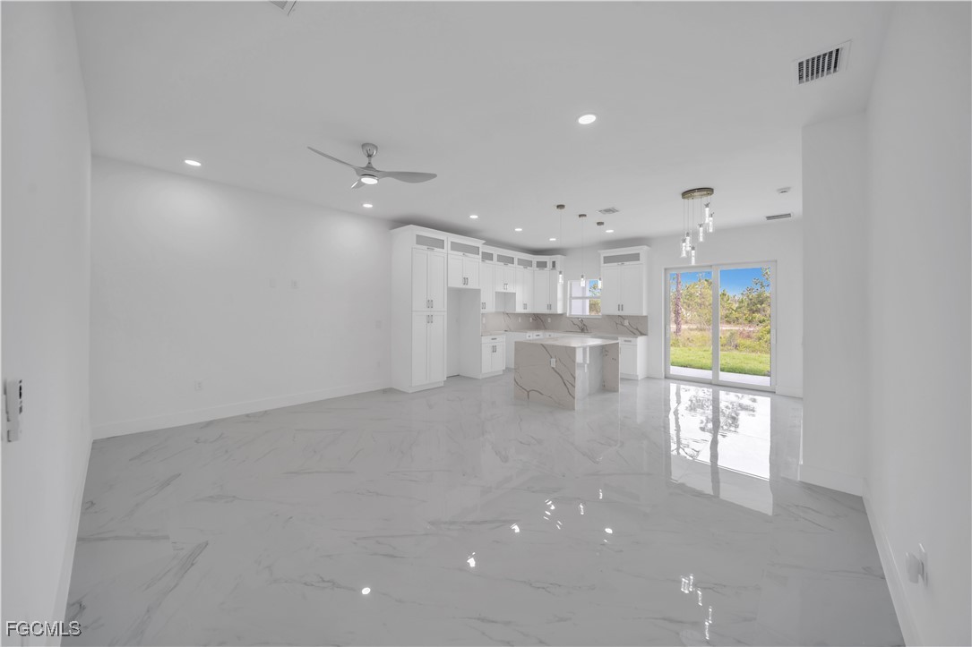 1155 Countess Avenue Lehigh Acres, FL 33974 - Photo 18 of 36 a view of kitchen with windows and refrigerator