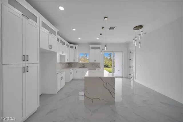 a view of kitchen with furniture and refrigerator