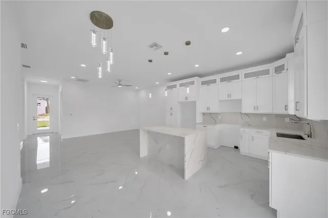 a large kitchen with white cabinets