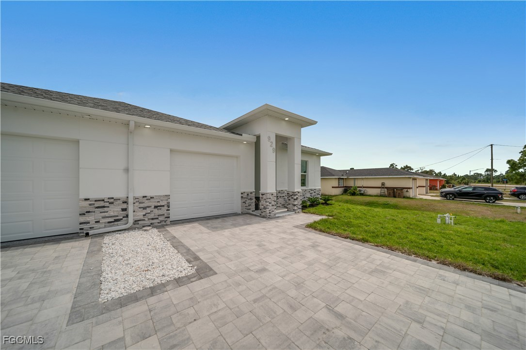 1155 Countess Avenue Lehigh Acres, FL 33974 - Photo 5 of 36 a view of a house with a patio