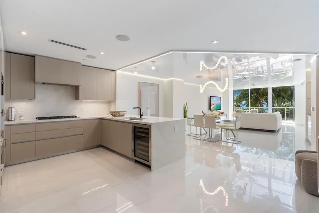 a kitchen with stainless steel appliances a sink a stove and a refrigerator