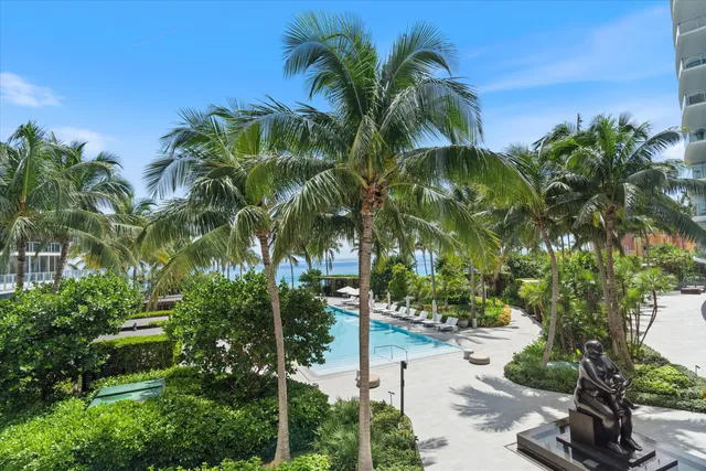 a view of a swimming pool with a patio and a yard
