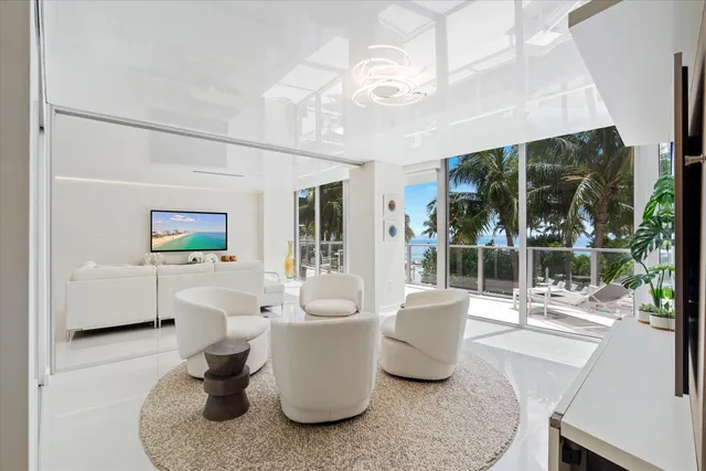 a living room with furniture a window and potted plants