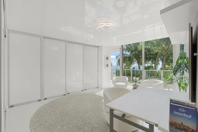 a kitchen with stainless steel appliances a table and chairs in it