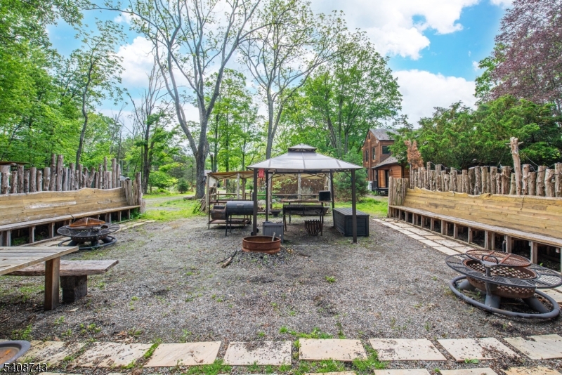 62 Mt Pleasant Road Columbia, NJ 07832 - Photo 21 of 46 a view of a wooden deck with chairs and a yard