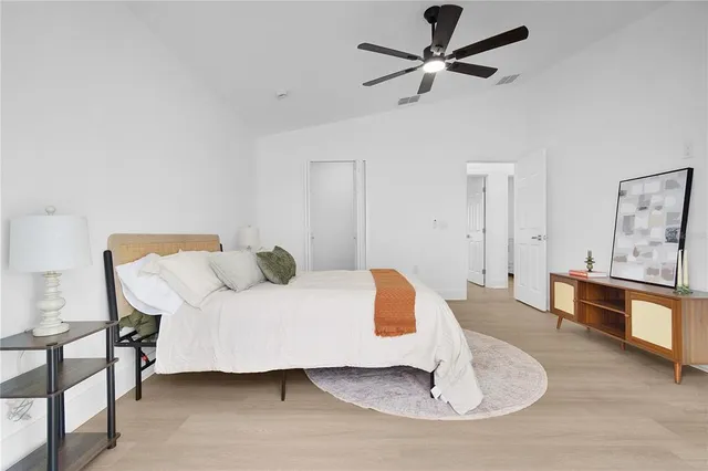 a bedroom with a bed and a window