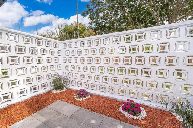 an empty room with a window and a ceiling fan
