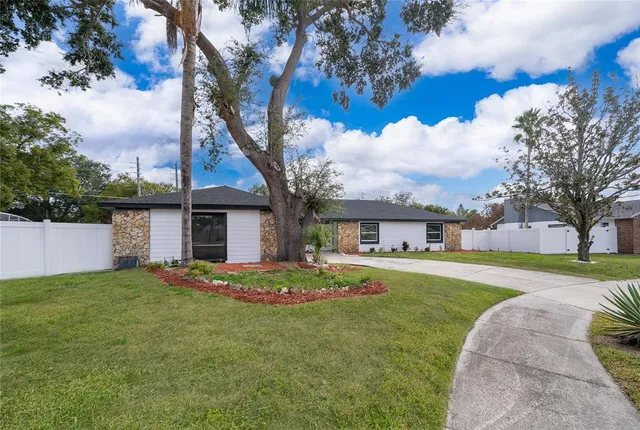 a living room with furniture kitchen view and a chandelier