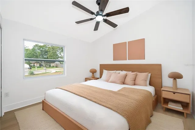 an empty room with a window and a ceiling fan