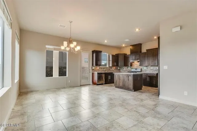 a view of a kitchen with a sink and cabinets