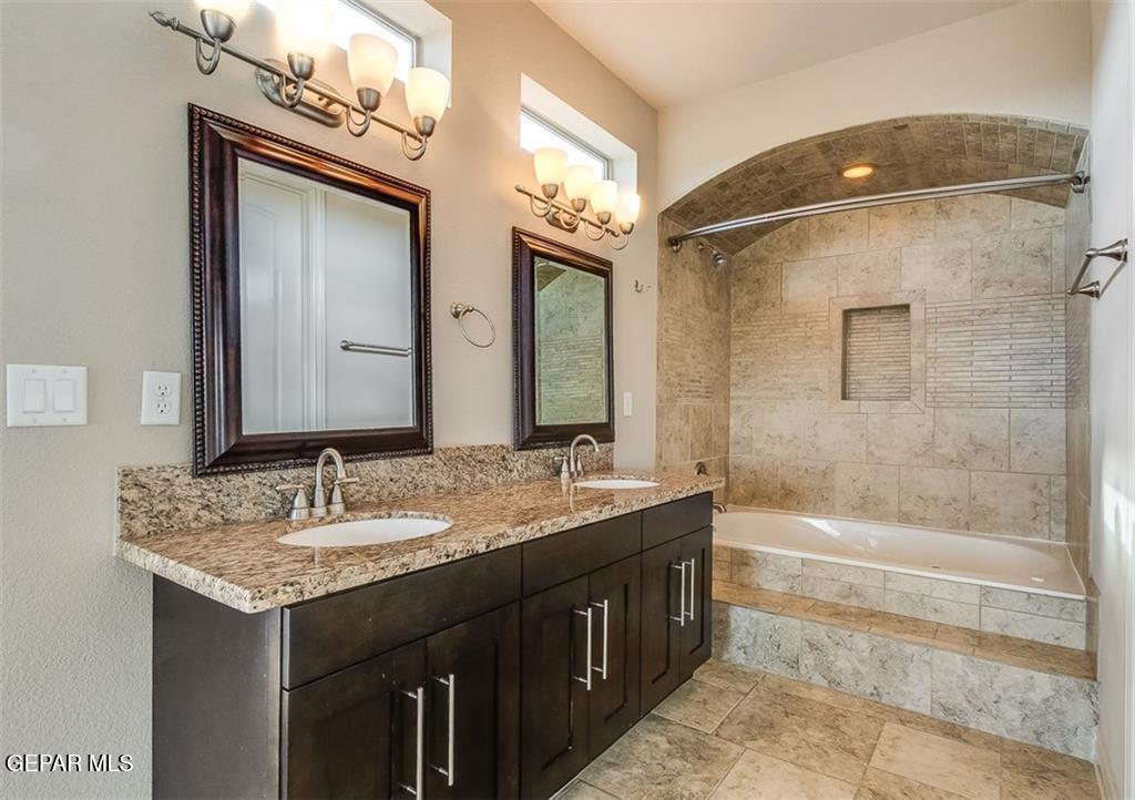 401 Ana Way, Unit B El Paso, TX 79912 - Photo 24 of 28 a bathroom with a granite countertop sink mirror and a